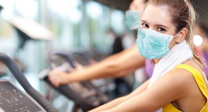 woman exercising with a mask on